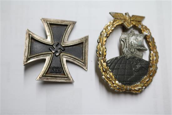 A German Iron Cross first class pin numbered and Naval auxiliary cruiser badge marked RS